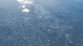 Bird's eye view of London Centre from a passenger plane landing in Luton Airport on a cloudy foggy evening.