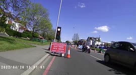 At temporary traffic lights a black car ignores them and speeds through.