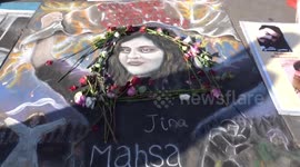 Flowers decorate beautiful portrait of Mahsa Amini on Trafalgar Square in London