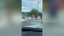 Brave men form human chain to save neighbour from being swept away by flood water