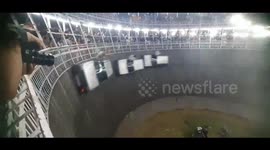 Riders and drivers perform crazy stunts on roaring vehicles in India's Well of Death