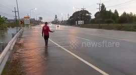 River overflows onto road following rain from Typhoon Noru in central Thailand