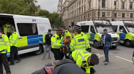 Police officers arrest Just Stop Oil climate activists who glued their hands to the roads
