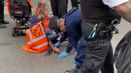Police use syringes of solvent to remove climate protesters who glued themselves to roads