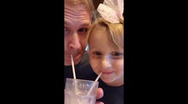 Father and daughter sharing drink. Cute blue eyed 4 year old, adorable child and dad