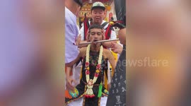 Thick metal rod pierces devotee's cheek in graphic 'purifying ritual' during Thai Vegetarian Festival
