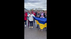 Locals in reclaimed town greet Ukrainian forces with flags and flowers