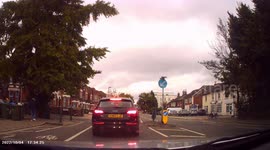 DASHCAM - Impatient Driver drives on WRONG SIDE OF ROAD at KEEP LEFT SIGN to turn off.