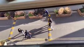 Moment armed police intervene after street fight in London