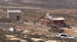 Bulldozers of Israeli security forces demolish a Palestinian house