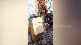 Talented artist with disability sketches portraits using his mouth