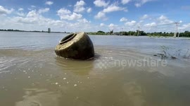 Large clay water jug found floating next to road amid floods in Thailand