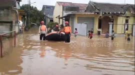 Rescue workers evacuate residents on dinghies as heavy rains hit Bekasi, Indonesia
