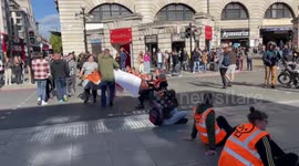 Man strips off Just Stop Oil activists of their banners to encourage them to leave roads