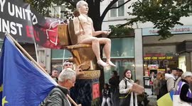 Statue of a naked Putin sitting on a gold toilet wheeled through streets of Prague