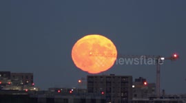 Full Moon rises over London's City Airport