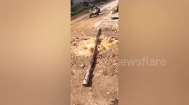 Column of water propelled into air from burst well in central China