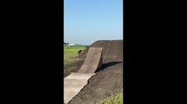 Biker falls after taking fast flight off ramp
