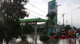 Gas station owner salvages fuel pumps as floods swamp forecourt in Thailand