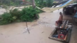 Swollen river floods adjacent homes due to thunderstorm in the Philippines