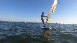 Windsurfer crash while wind surfing with another sportsperson at mar menor in Murcia,