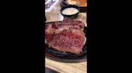 Sound of a nice steak sizzling on a cast iron plate. August 2022