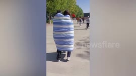 Girls wrap themselves in quilt as they head to COVID-19 test in freezing conditions