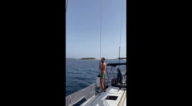 Wrecking ball: Man jumps off the edge of boat and rides sailing rope