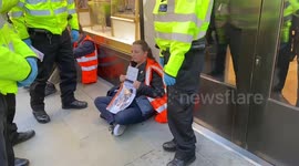 Police attempt to remove Just Stop Oil activists blocking road in London