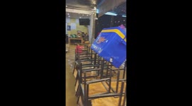 Restaurant owner battles to stop furniture from being swept away by floods in Vietnam