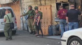 Israeli forces close shops in Bab Al-Zawiya in the West Bank city of Hebron.