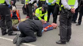 Authorities work to remove Insulate Britain activists glued to road outside Parliament