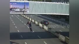 Bus driver stops vehicle to catch worker dangling from overpass in China