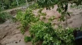 Raging torrent gushes under bridge after storm in the Philippines