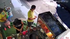 Time-lapse footage shows flood emerging from manhole cover in Thai market