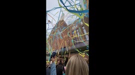 People run inside restored Battersea Power Station as colorful streamers fall from sky