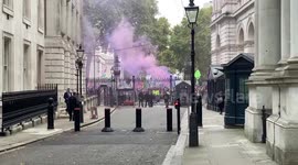 Extinction Rebellion activists protest with flares outside Downing Street as Kwasi Kwarteng is sacked