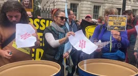 Protesters burn energy bills outside London's Downing Street