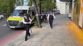 Police secure the scene after Just Stop Oil activists cover Aston Martin's Park Lane dealership with paint