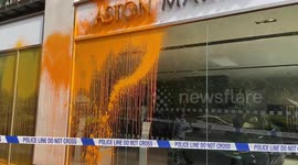 Police tape off the scene after Just Stop Oil activists throw paint at Aston Martin's Park Lane shop