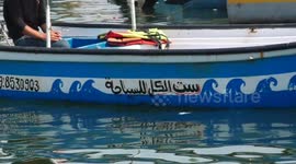 Palestinian fisherman, Khader Bakr, 30, works on a tourist boat at the port of Gaza City