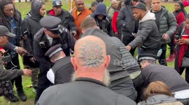A Man is held down by security and police at March against Historic sexual abuse in Brixton