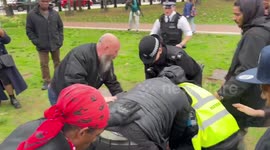 A man is held down by security and police at His Time Is Up protest in South London