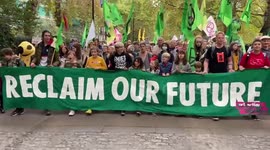 Thousands of Extinction Rebellion supporters march through London to the beat of drums