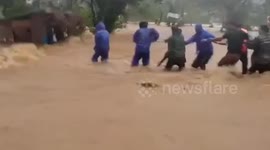 Police rescue villager, 50, trapped in his shanty amid raging floods in the Philippines