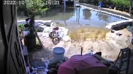 Swollen river breaks through sandbag levee flooding nearby homes in Thailand