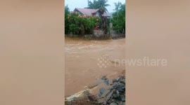 Flood cascades down road during Typhoon Nesat rains in the Philippines