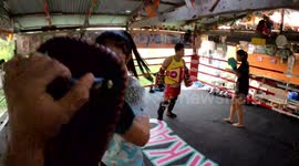 FPV video shows female Muay Thai fighter training in boxing ring