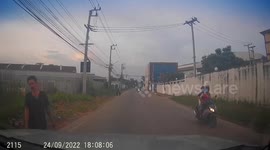 Bizarre moment man runs into path of oncoming car