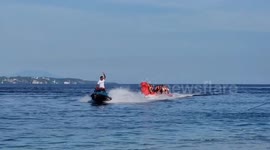 Proud tourist is the only person who stays onboard wobbly banana boat ride